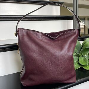 Fossil, genuine, leather, purple bucket handbag, tiny hole in bottom corner.